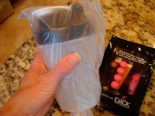 Hand holding cup wrapped in plastic