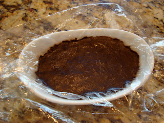 Ingredients pressed into dish lined in plastic wrap