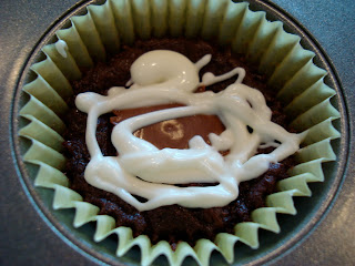 Close up of one Peanut Butter Cup Brownie Cupcake with White Chocolate Icing