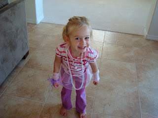 Young girl playing dress up