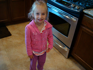 Young girl in pink standing in kitchen