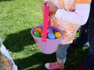 Child holding basket full of Easter eggs