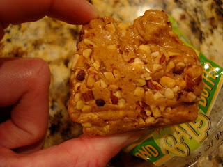 Hand holding one Betty Lou's High Protein Almond Butter Ball