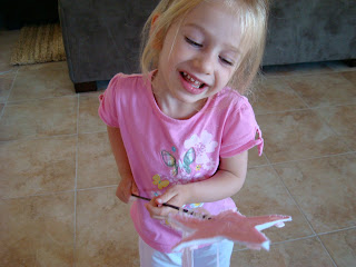 Young girl smiling holding princess wand