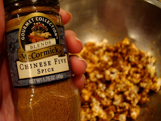 Hand holding jar of Chinese Five Spice