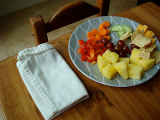 Childs plate full of fruits and vegetables