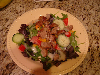 Mixed salad in shallow bowl topped with sliced turkey meatballs