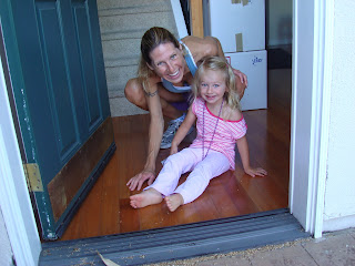 Woman and little girl on floor smiling