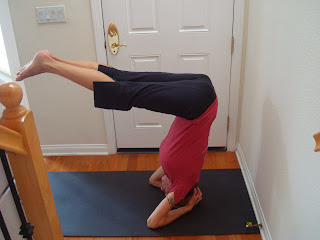 Woman doing half headstand yoga pose