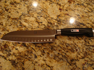 Large black handled knife laying on countertop