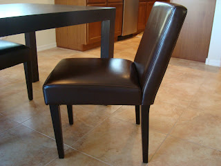 Leather dining room chair pulled slightly. away from table