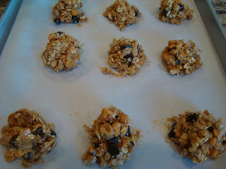 Maple Nut Chocolate Oat Clusters shaped on parchment lined baking sheet