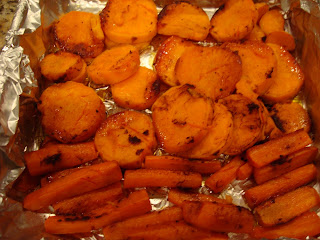 Roasted Sweet Potatoes and Carrots in foil lined pan with glaze
