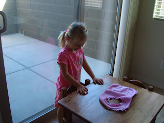 Young girl in pink playing at child's sized table