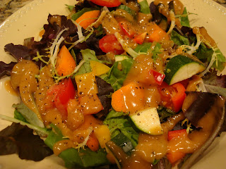 Bowl of mixed greens with diced vegetables with Homemade Peanut Sauce