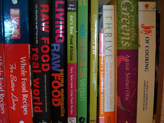 Various cookbooks stacked on shelf