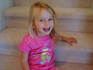 Smiling young girl sitting on steps