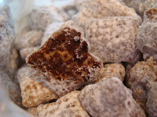 Chex mix in bowl with one split open showing chocolate inside