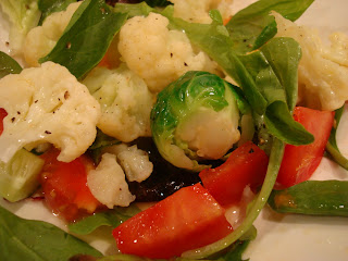 Mixed greens with vegetables topped with dressing