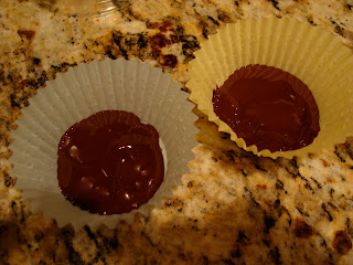 Paper muffin liners with bottoms spread with melted chocolate 