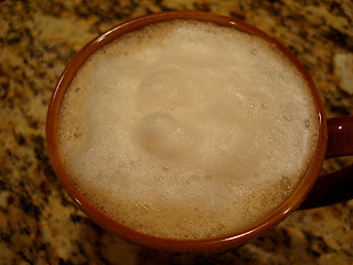 Overhead of steamed almond milk in mug