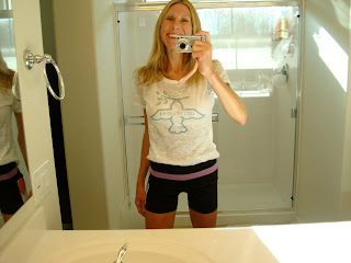 Woman taking photo in mirror wearing Lululemon clothing