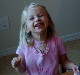 Young girl smiling wearing pink shirt