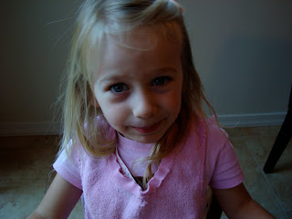 Young girl in pink smiling