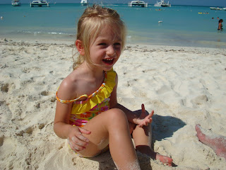 Young girl smiling while playing in sand