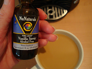 Hand holding NuNaturals Vanilla Stevia Drops