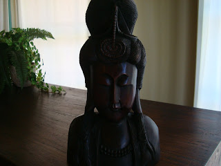 Dark chocolate-colored wooden statue on table