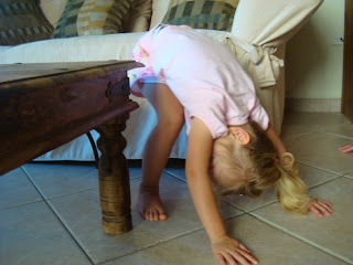 Young girl practicing Downward Dog yoga pose