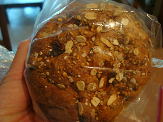 Hand holding a package of local grain bread
