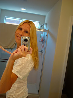 Mirror photo of woman showing new hair color