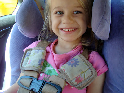 Close up of young girl buckled into car seat - 21