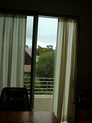 Curtains on window with open door to balcony