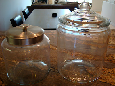 Two different sized glass canisters on countertop