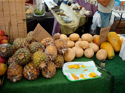 Pineapple, mangos and papaya on table