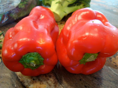 Two red peppers on countertop