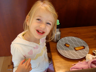 Young girl sitting at table eating