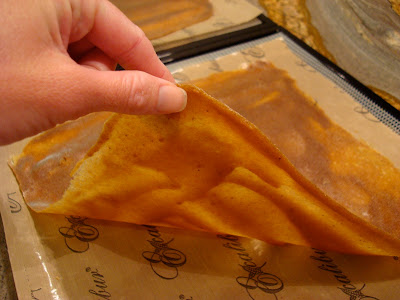 Hand flipping crepe on tray