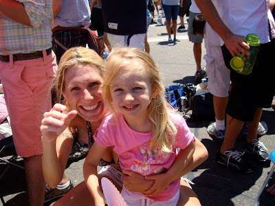 Woman and child crouching smiling at Gay Pride Parade