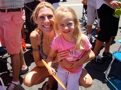 Woman squatting next to young girl at Gay Pride Parade