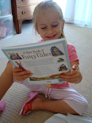 Young girl looking at A Book of Fairy Tales