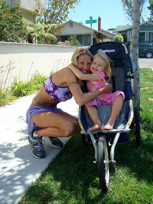 Woman and young girl hugging while in stroller