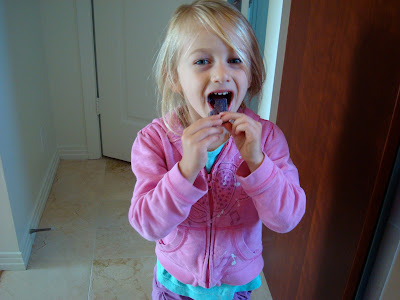 Young girl eating one Terra Blues Potato Chip