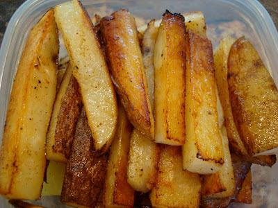 Finished Coconut & Olive Oil Roasted Potato Sticks stacked in container