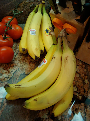 Bunches of bananas and vine tomatoes