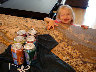 Young girl reaching for drinks on countertop