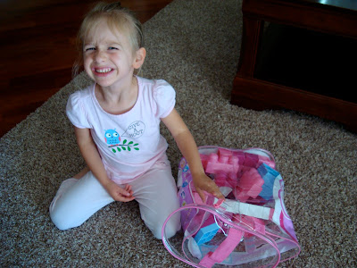 Young girl sitting on floor playing with blocks